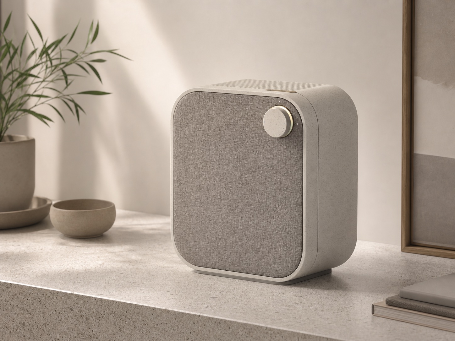 Compact home air purifier concept with fabric grille and ceramic-like body.